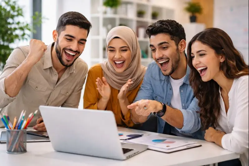 Professional web design and development team celebrating a successful digital project